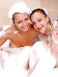 Naughty sexy young chicks taking a hot bubble bath together pictures