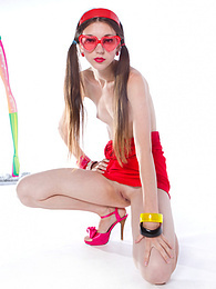 Gorgeous dark haired teen girl with red glasses in the shape of hearts posing with tape recorder. pictures
