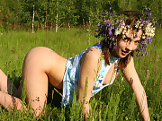 Alluring cutie wearing a garland of flowers shows off her most intimate parts in the field
